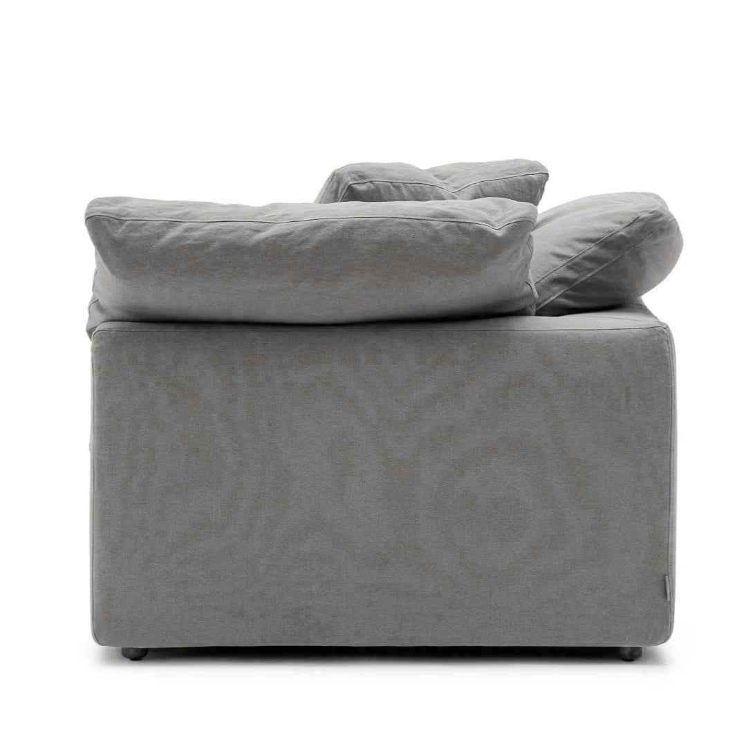 Side view of a gray HavenlyCloud® Couch Corner in Performance Fabric, featuring large, fluffy cushions and a boxy design reminiscent of the Modular Clouds collection.